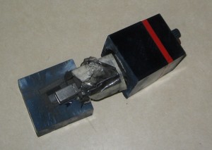 This picture clearly shows how the bottom inch of the "Extra Charcoal" appliance is molded into the case. The plastic tape, which is layered on top of the white tape, is also clearly visible.  The Extra Charcoal appliance does actually have charcoal, but it does not fully surround the Carbon/Steel/Glass core. 